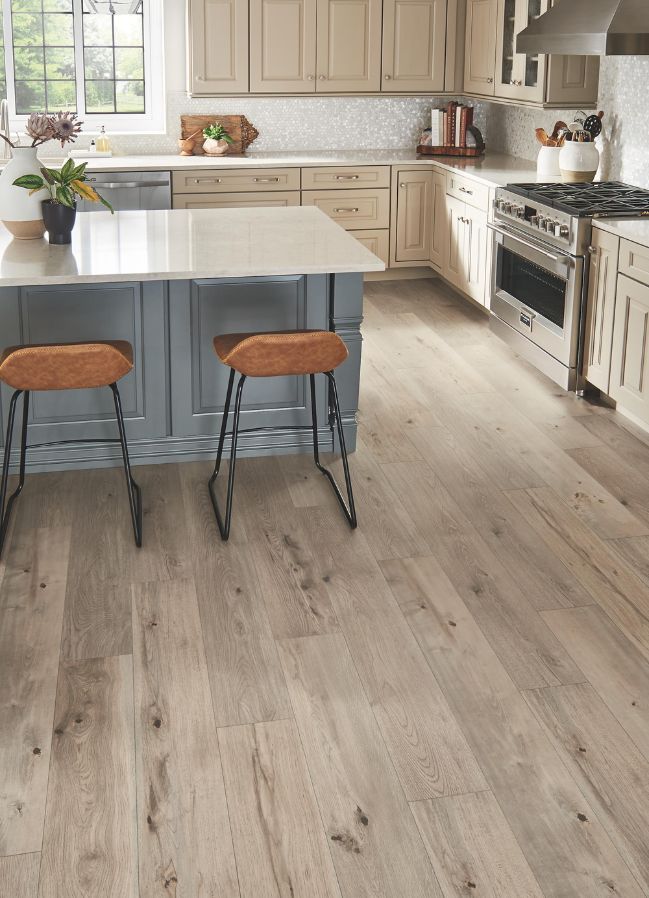 wood look laminate floors in a ktichen with island and beige cabinets