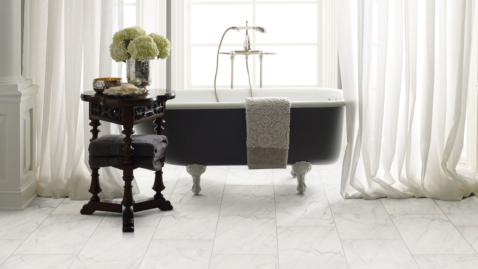 tile flooring in a bright white bathroom with a tub